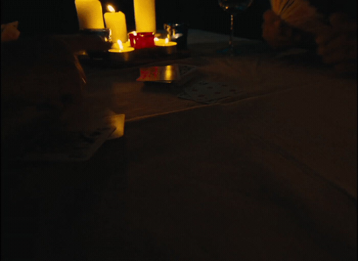 a table topped with candles and a wine glass