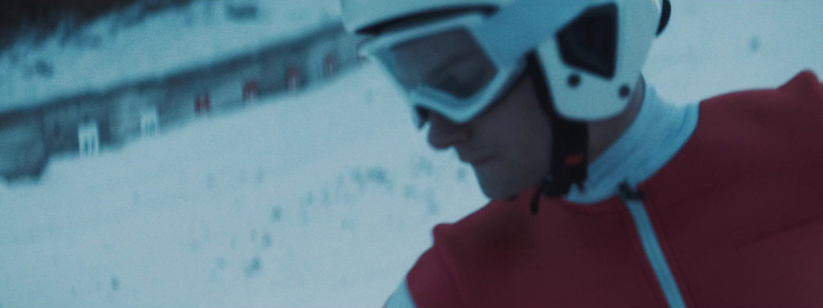 a man wearing a helmet and goggles in the snow