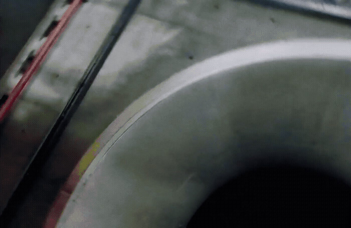 a close up of a white toilet with a red handle