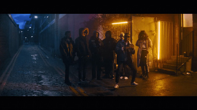 a group of people standing on a street at night