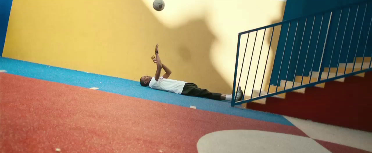 a man laying on the ground in front of a stair case