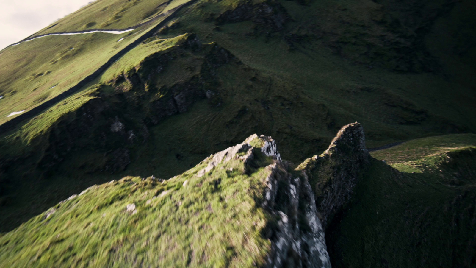 a view of the top of a green mountain