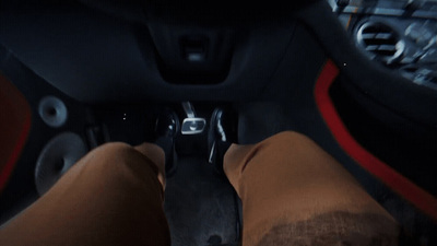 a person sitting in a car with their feet up