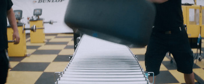 a man standing next to a conveyor belt