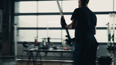 a man holding a large metal object in a room