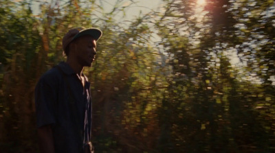 a man standing in front of a forest