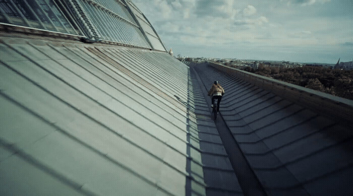 a person walking down a walkway next to a building