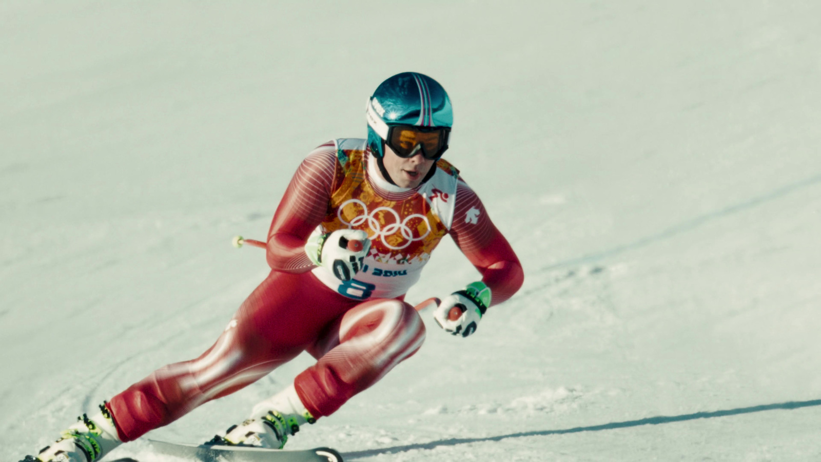 a woman is skiing down a snowy hill