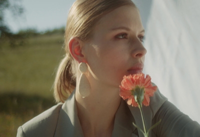 a woman with a flower in her mouth