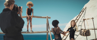 a group of people standing on top of a wooden bridge