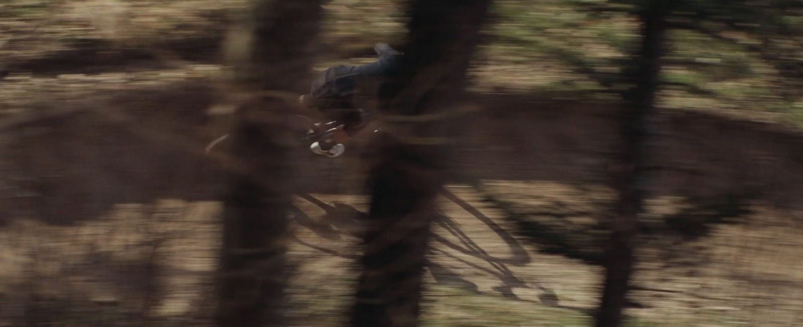 a man riding a bike through a forest