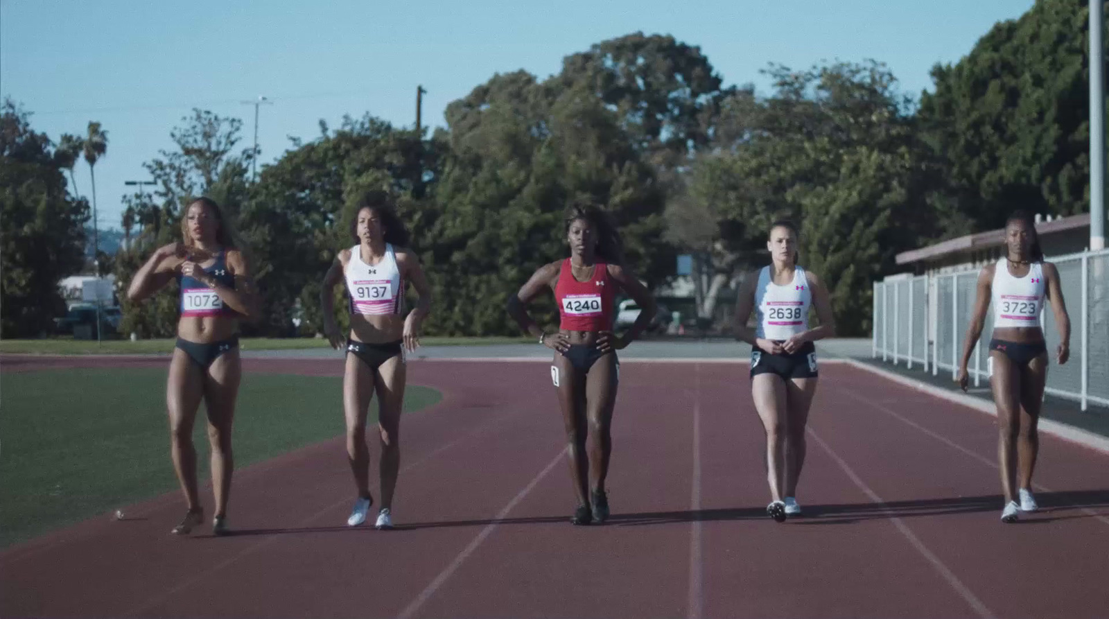 a group of women running on a track