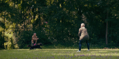 a man and a woman playing frisbee in a field