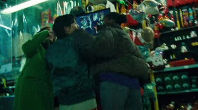 a couple of people standing in front of a store