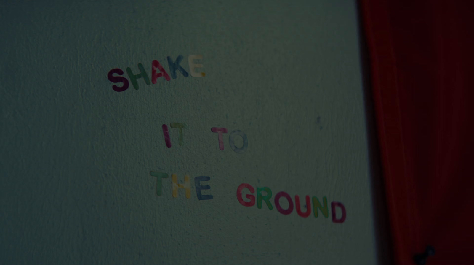 a white wall with writing on it that says shake it to the ground