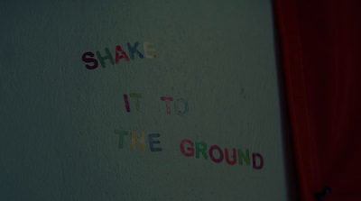 a white wall with writing on it that says shake it to the ground