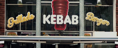 a large kebab sign on the side of a building