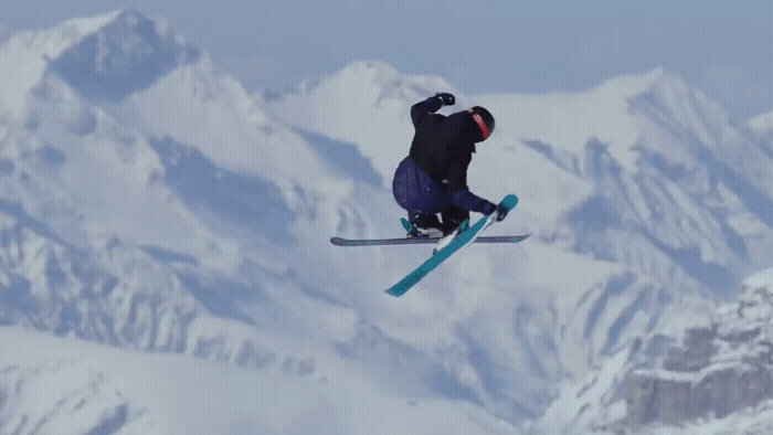 a man flying through the air while riding skis