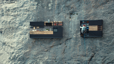 a couple of small houses sitting on top of a cliff