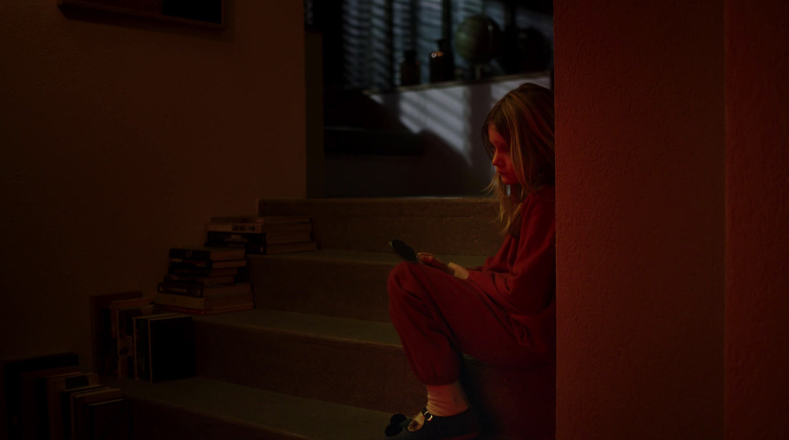 a woman sitting on the stairs looking at her cell phone