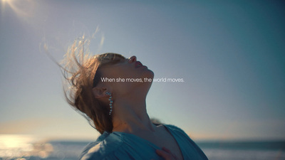 a woman with her hair blowing in the wind