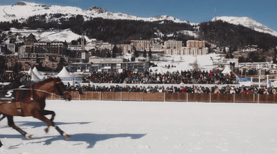 a man riding on the back of a brown horse