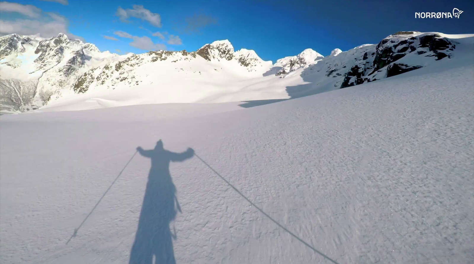 a shadow of a person on skis in the snow