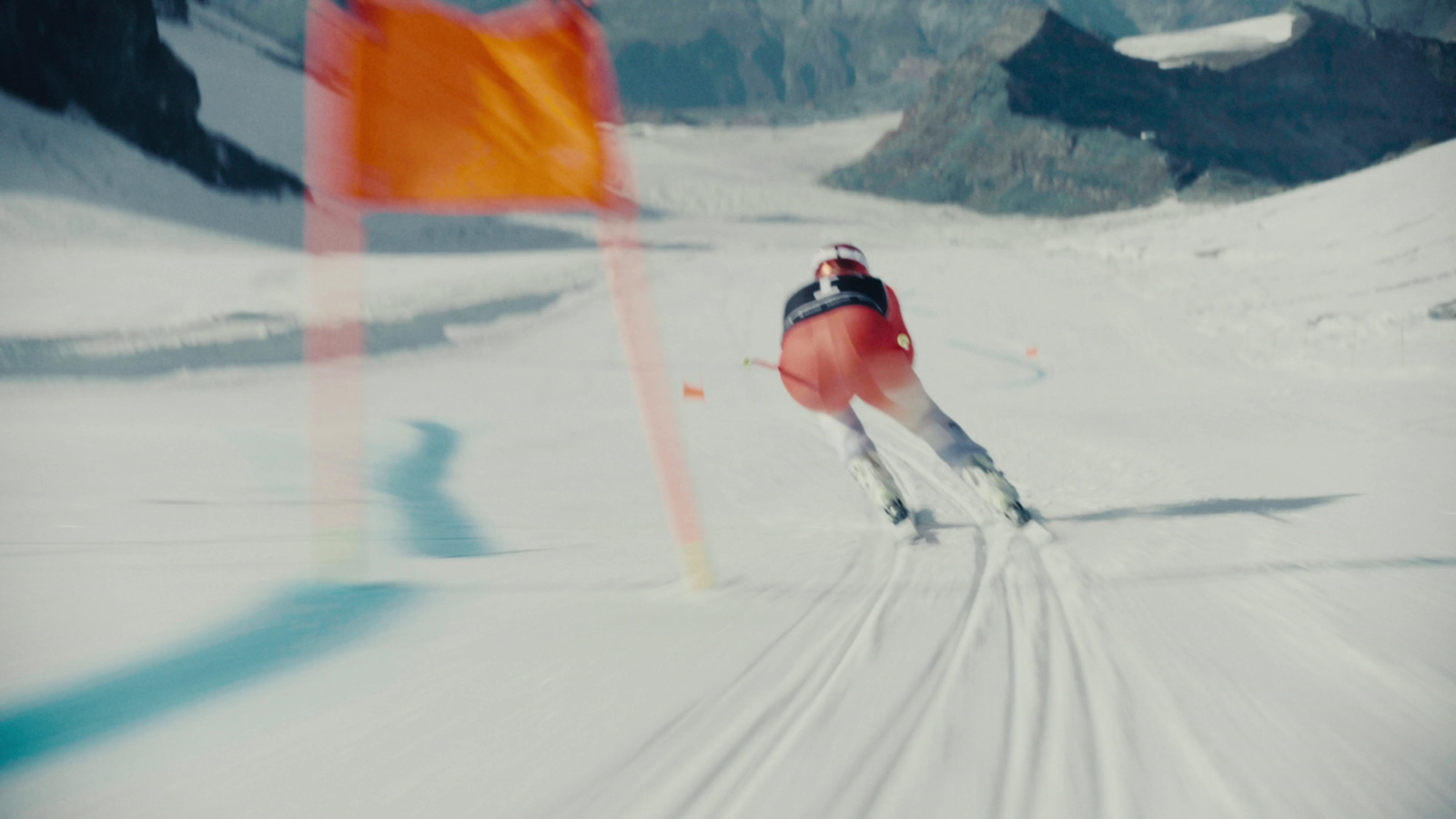 a man riding skis down a snow covered slope