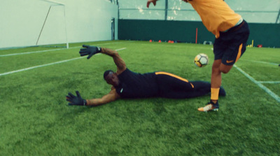 a man laying on the ground next to a soccer ball