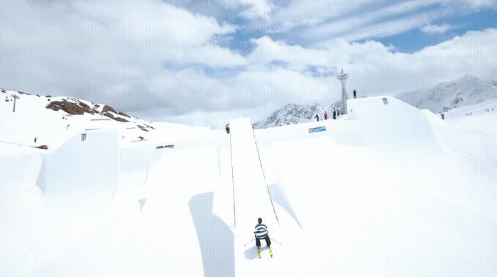 a man riding skis down a snow covered slope