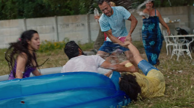 a group of people playing in an inflatable pool