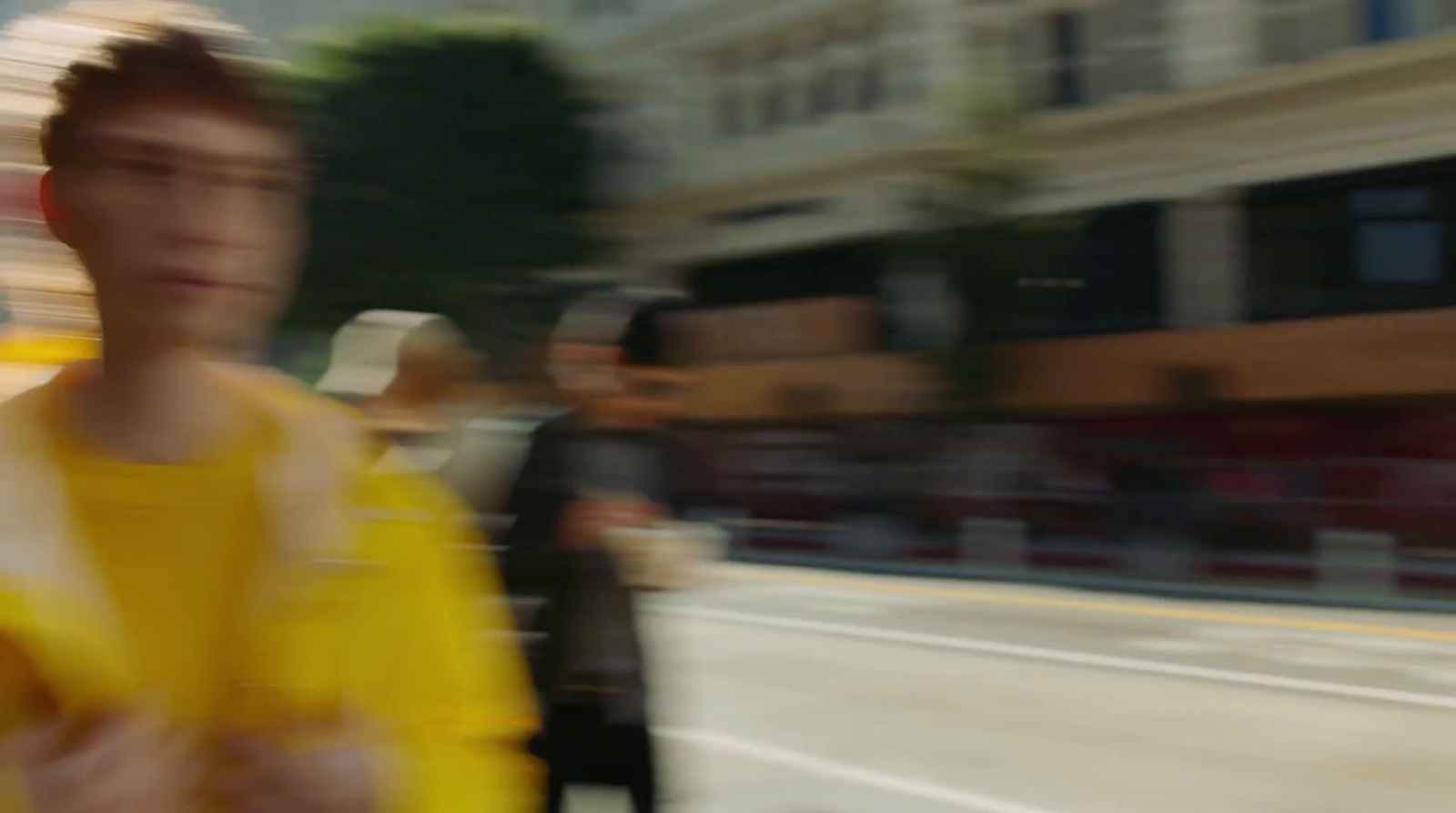 a blurry photo of a man in a yellow shirt