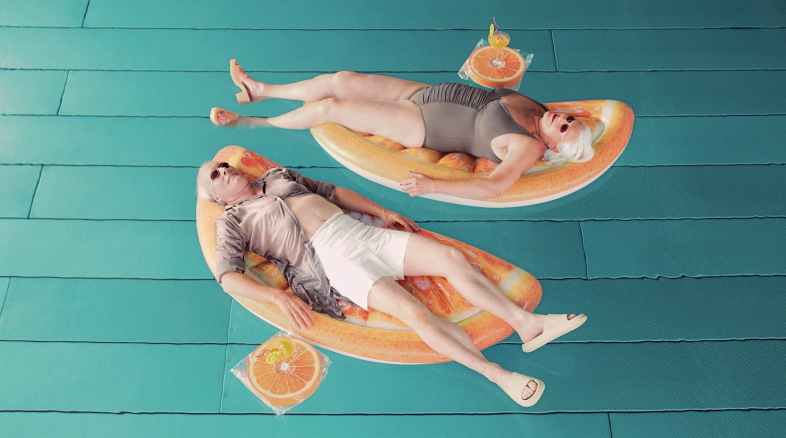 a couple of people that are laying on some floaties