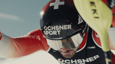 a man riding skis down a snow covered slope