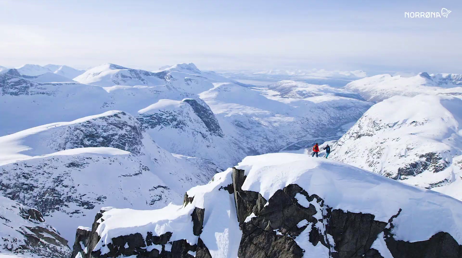 a man standing on top of a snow covered mountain