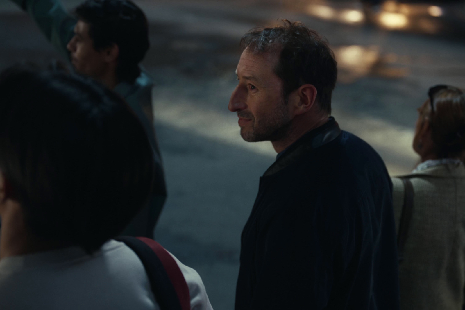 a man standing next to a woman on a street