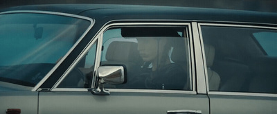 a man driving a car with a woman in the passenger seat