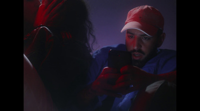 a man in a red hat looking at his cell phone