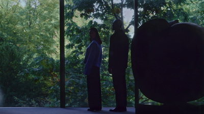 a couple of people standing in front of a window