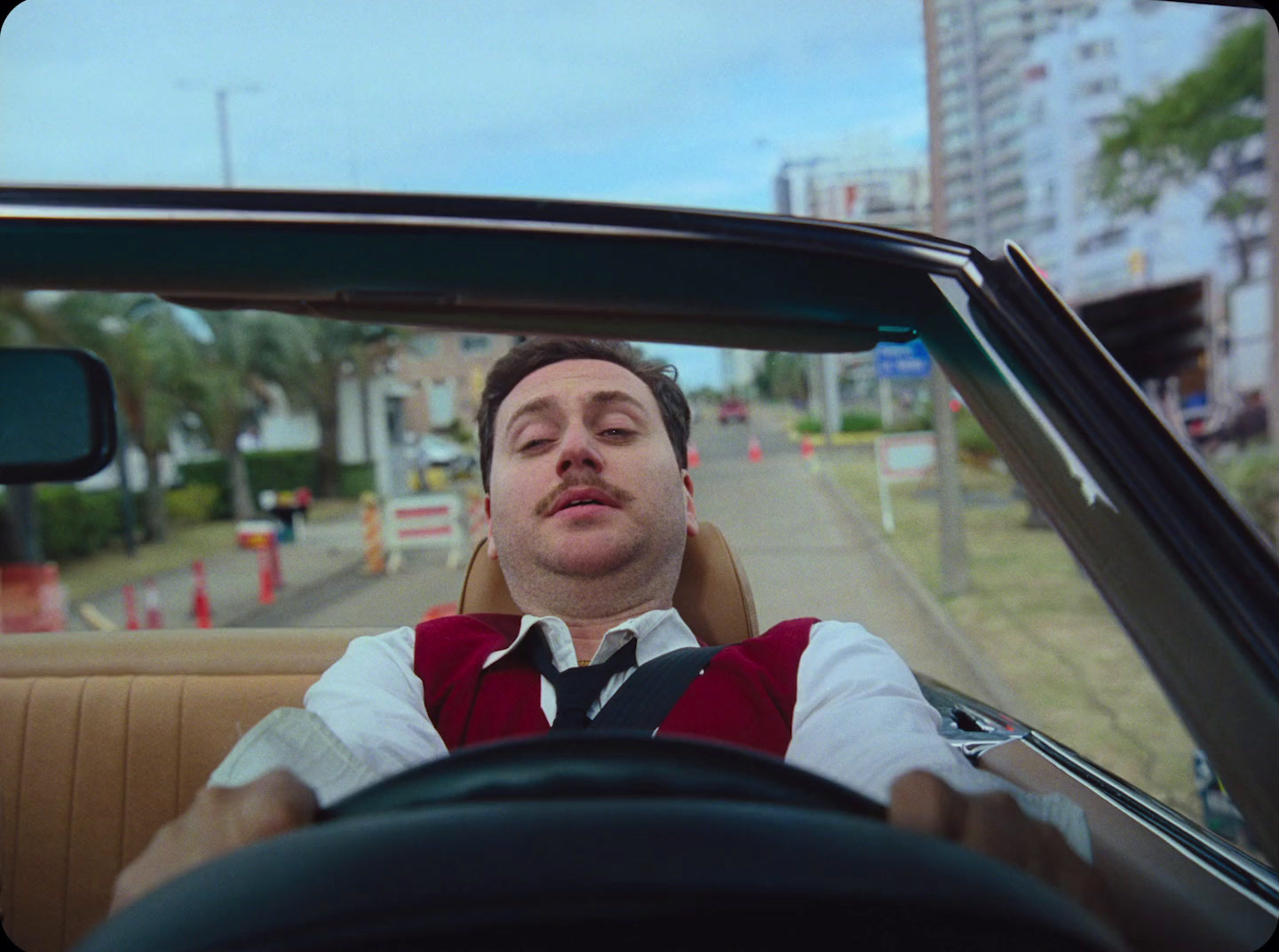 a man sitting in the back seat of a car