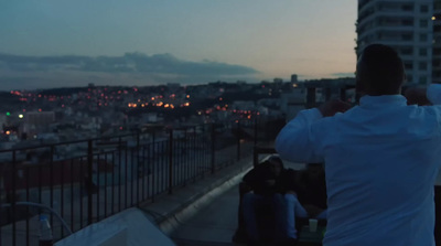 a man taking a picture of a city at night