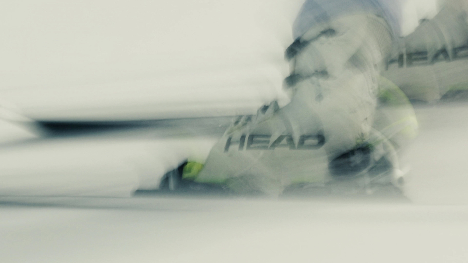 a man riding skis down a snow covered slope