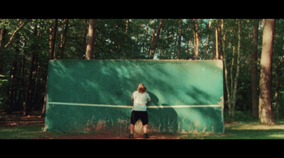 a man holding a tennis racquet on top of a tennis court