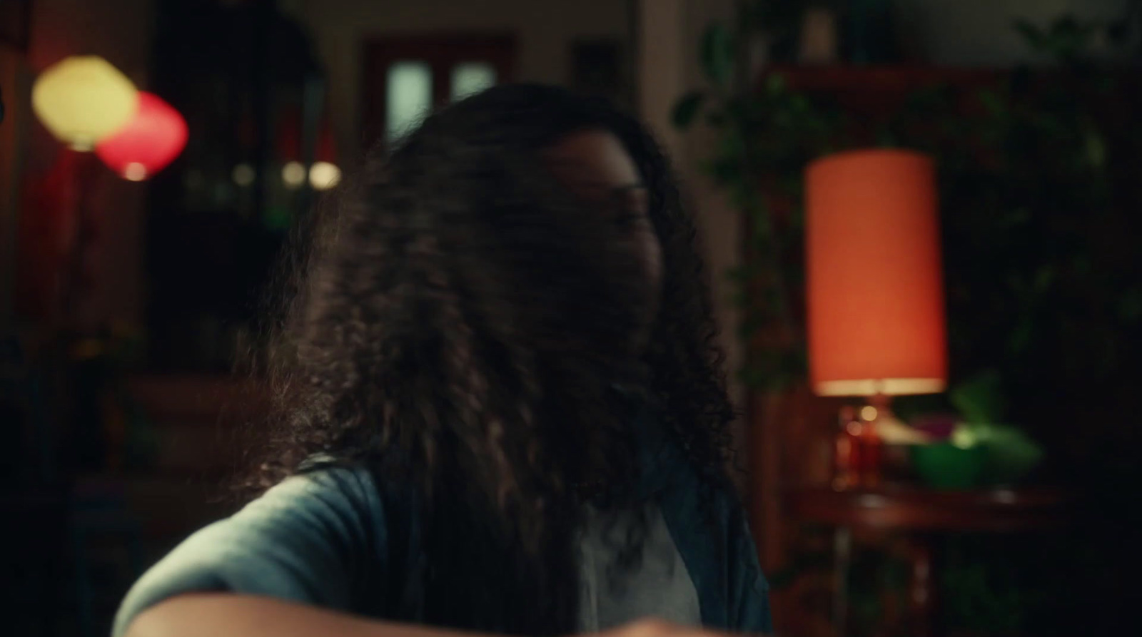 a woman with long hair standing in a room