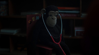 a stuffed monkey with a stethoscope in a room