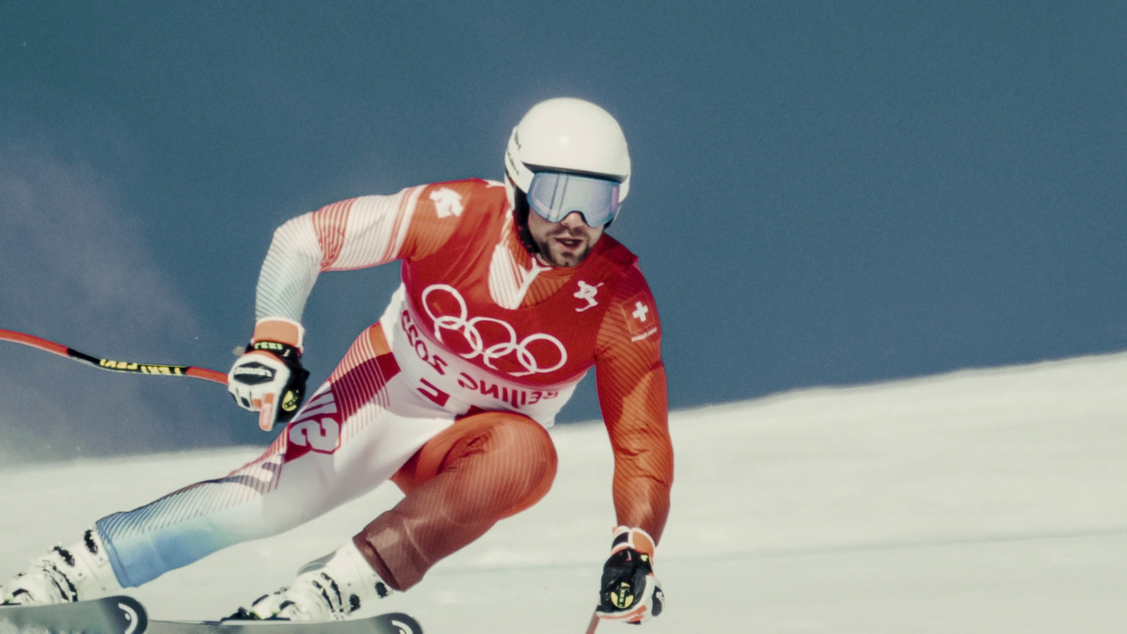 a man riding skis down a snow covered slope