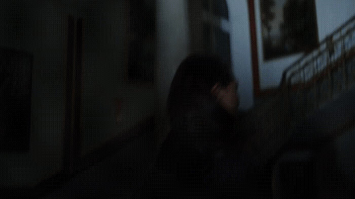 a blurry photo of a woman walking down a hallway