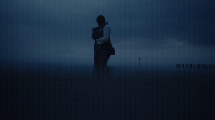 a person standing in the middle of a field at night