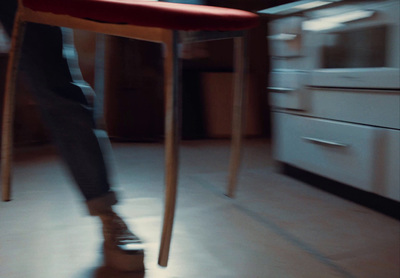 a person standing on a stool in a kitchen