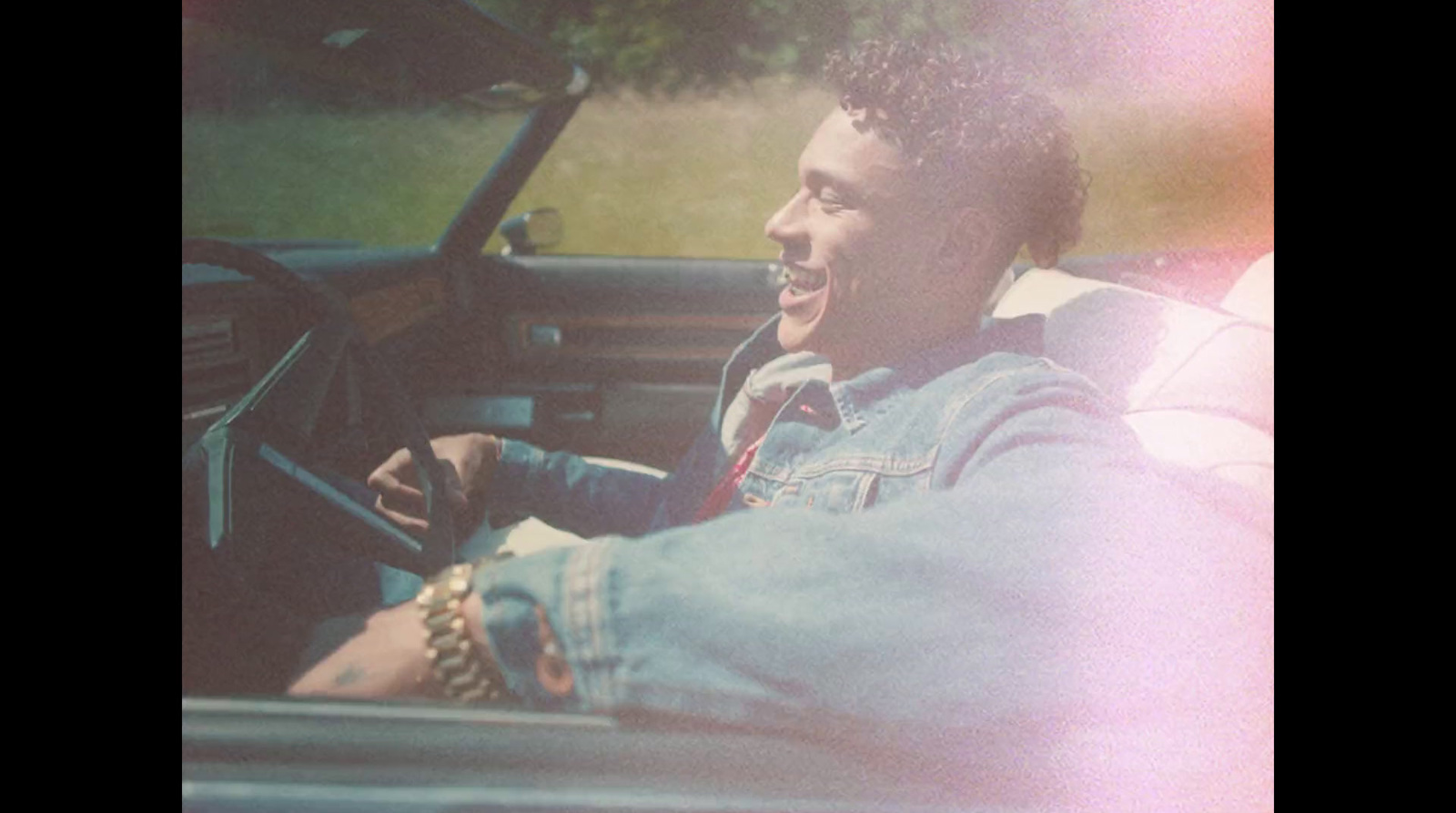 a man sitting in the driver's seat of a car